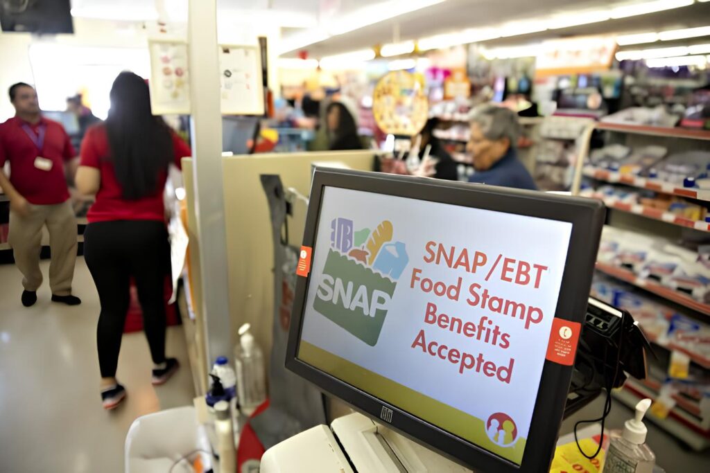 SNAP recipients using EBT cards at grocery store checkout